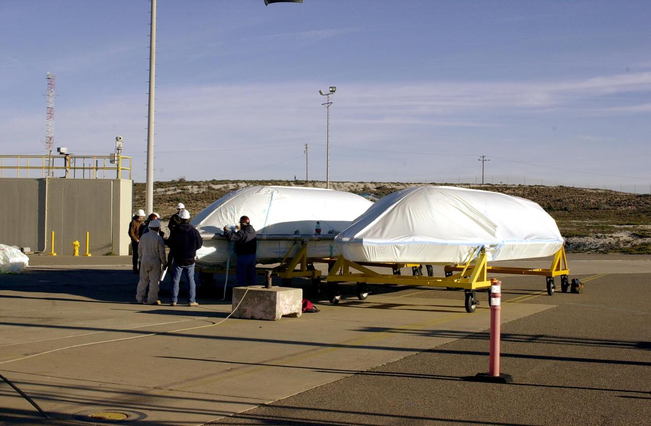 VANDENBERG AIR FORCE BASE, CALIF. -  On Space Launch Complex 2 at Vandenberg Air Force Base in California, the two fairing sections for the National Oceanic and Atmospheric Administration (NOAA-N) spacecraft are ready to be lifted up the launch service tower.  The fairing is placed around the spacecraft to protect it during launch.  NOAA-N is the fourth in the series of support dedicated microwave instruments for the generation of temperature, moisture, surface, and hydrological products in cloudy regions where visible and infrared (IR) instruments have decreased capability.  Launch aboard a Boeing Delta II rocket is currently scheduled for no earlier than May 11, 2005.