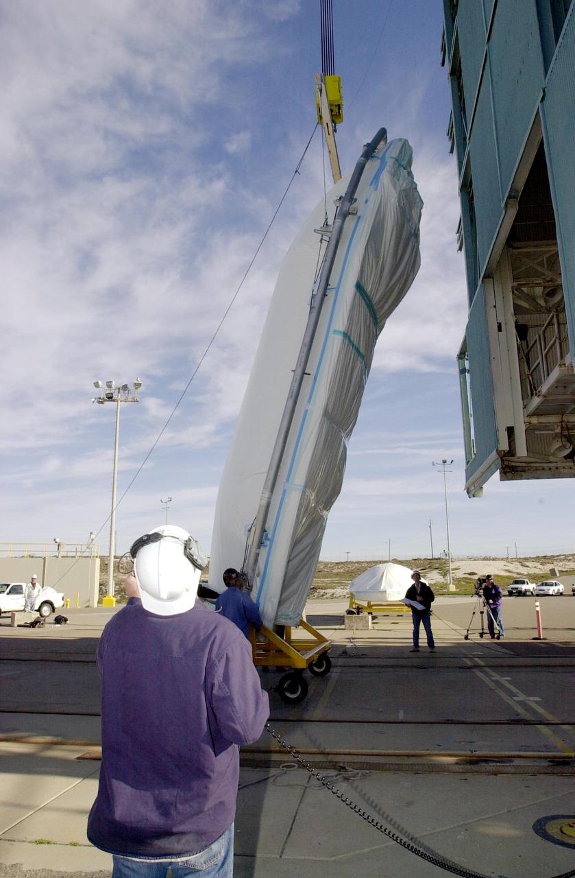VANDENBERG AIR FORCE BASE, CALIF. - On Space Launch Complex 2 at Vandenberg Air Force Base in California, one of the two fairing sections for the National Oceanic and Atmospheric Administration (NOAA-N) spacecraft is raised to a vertical position for lifting up into the launch service tower.  The fairing will be placed around the spacecraft to protect it during launch.  NOAA-N is the fourth in the series of support dedicated microwave instruments for the generation of temperature, moisture, surface, and hydrological products in cloudy regions where visible and infrared (IR) instruments have decreased capability.  Launch aboard a Boeing Delta II rocket is currently scheduled for no earlier than May 11, 2005.