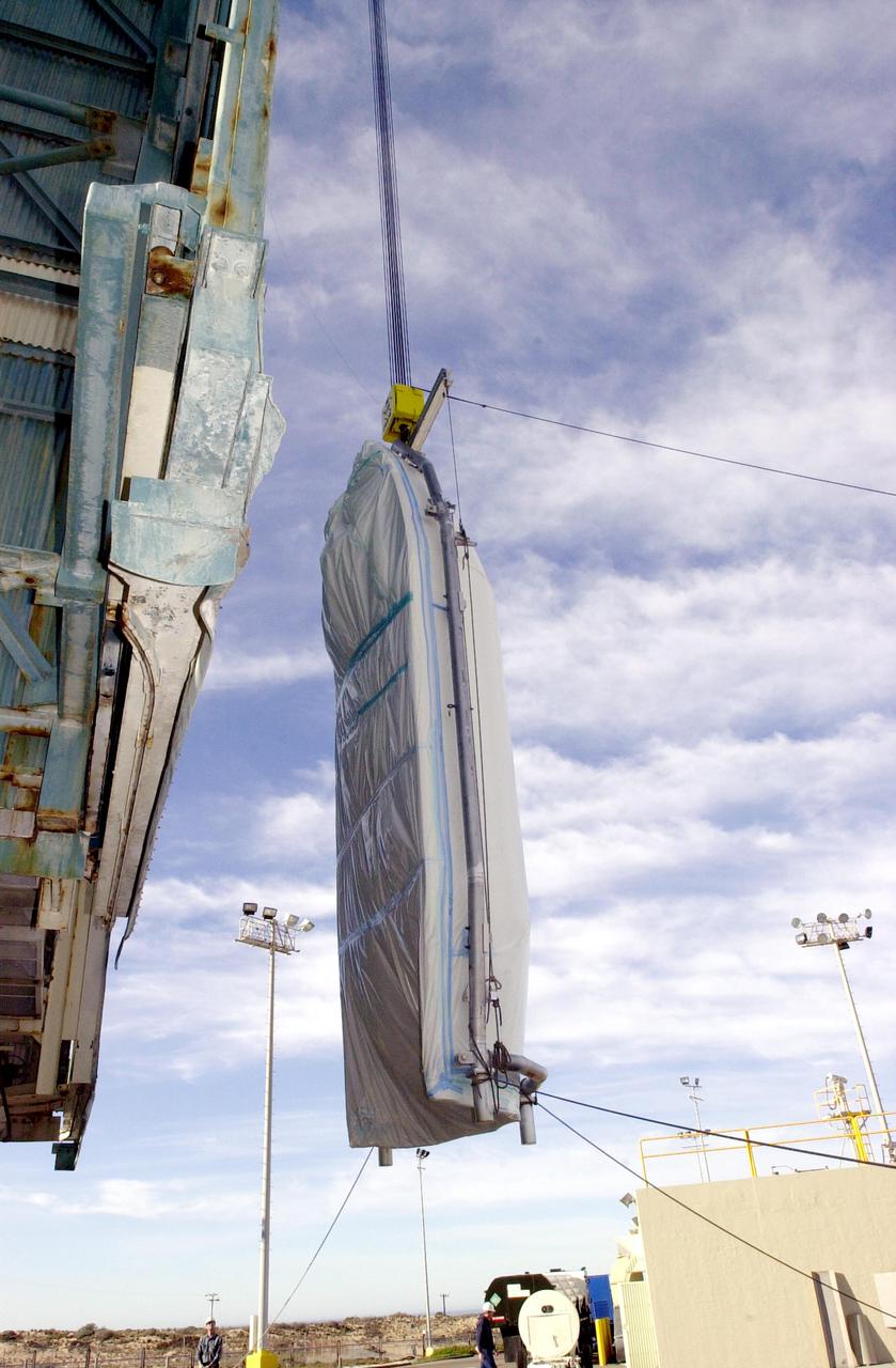 VANDENBERG AIR FORCE BASE, CALIF. - On Space Launch Complex 2 at Vandenberg Air Force Base in California, one of the two fairing sections for the National Oceanic and Atmospheric Administration (NOAA-N) spacecraft is being lifted up into the launch service tower.  The fairing will be placed around the spacecraft to protect it during launch.  NOAA-N is the fourth in the series of support dedicated microwave instruments for the generation of temperature, moisture, surface, and hydrological products in cloudy regions where visible and infrared (IR) instruments have decreased capability.  Launch aboard a Boeing Delta II rocket is currently scheduled for no earlier than May 11, 2005.