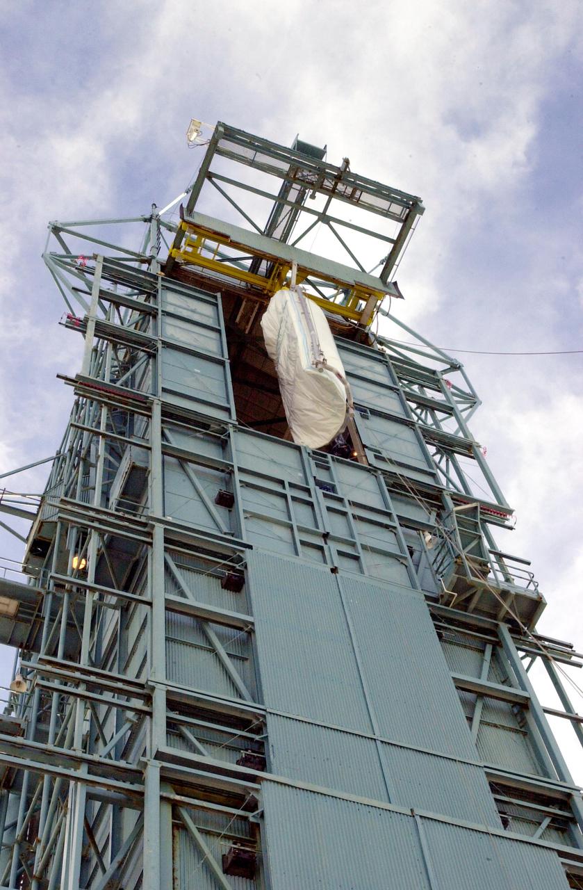 VANDENBERG AIR FORCE BASE, CALIF. - On Space Launch Complex 2 at Vandenberg Air Force Base in California, one of the two fairing sections for the National Oceanic and Atmospheric Administration (NOAA-N) spacecraft is being lifted up to an upper level of the launch service tower.  The fairing will be placed around the spacecraft to protect it during launch.  NOAA-N is the fourth in the series of support dedicated microwave instruments for the generation of temperature, moisture, surface, and hydrological products in cloudy regions where visible and infrared (IR) instruments have decreased capability.  Launch aboard a Boeing Delta II rocket is currently scheduled for no earlier than May 11, 2005.