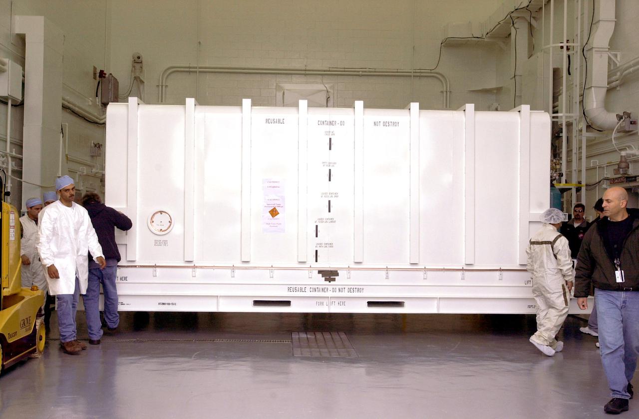 VANDENBERG AIR FORCE BASE, CALIF. - At Vandenberg Air Force Base in California, the container holding the National Oceanic and Atmospheric Administration (NOAA-N) spacecraft arrives inside a hangar where it will undergo preflight processing.  NOAA-N is the fourth in the series of support dedicated microwave instruments for the generation of temperature, moisture, surface, and hydrological products in cloudy regions where visible and infrared (IR) instruments have decreased capability.  Launch aboard a Boeing Delta II rocket is currently scheduled for no earlier than May 11, 2005.