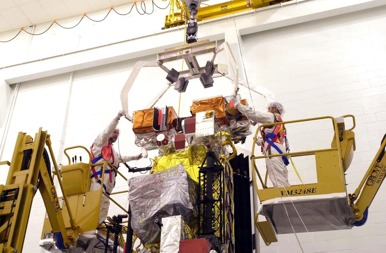 VANDENBERG AIR FORCE BASE, CALIF. - Inside the NASA spacecraft processing hangar 1610 located on North Vandenberg Air Force Base in California,  Lockheed Martin workers attach a crane to move the National Oceanic and Atmospheric Administration (NOAA-N) spacecraft.  NOAA-N will be lifted and mated to the Boeing Delta II payload attach fitting.  Launch of NOAA-N aboard the Boeing Delta II rocket is currently scheduled for May 11, 2005.  NOAA-N is the fourth in the series of support dedicated microwave instruments for the generation of temperature, moisture, surface, and hydrological products in cloudy regions where visible and infrared (IR) instruments have decreased capability.