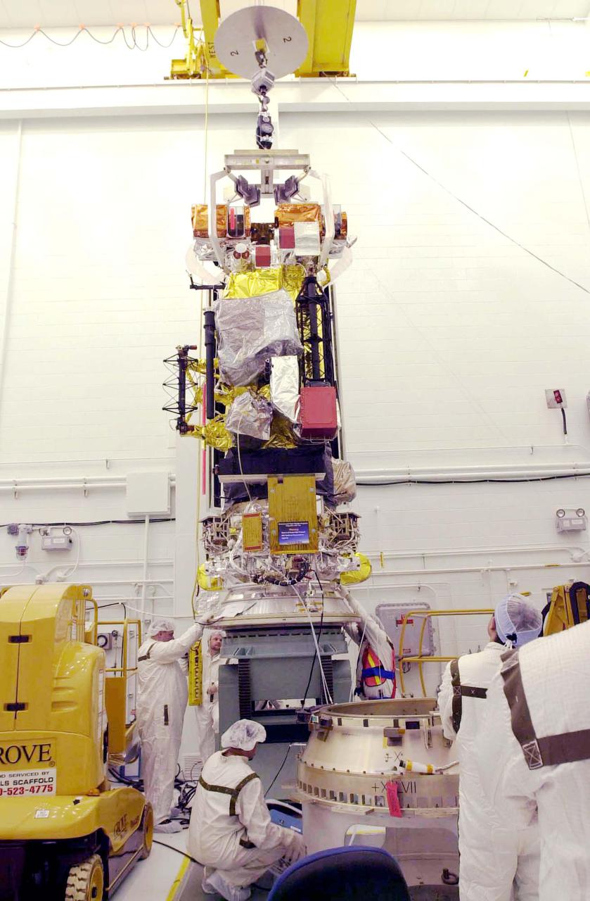 VANDENBERG AIR FORCE BASE, CALIF. - Inside the NASA spacecraft processing hangar 1610 located on North Vandenberg Air Force Base in California,  Lockheed Martin workers help guide the suspended National Oceanic and Atmospheric Administration (NOAA-N) spacecraft toward the Boeing Delta II payload attach fitting in the foreground.  Launch of NOAA-N aboard the Boeing Delta II rocket is currently scheduled for May 11, 2005.  NOAA-N is the fourth in the series of support dedicated microwave instruments for the generation of temperature, moisture, surface, and hydrological products in cloudy regions where visible and infrared (IR) instruments have decreased capability.