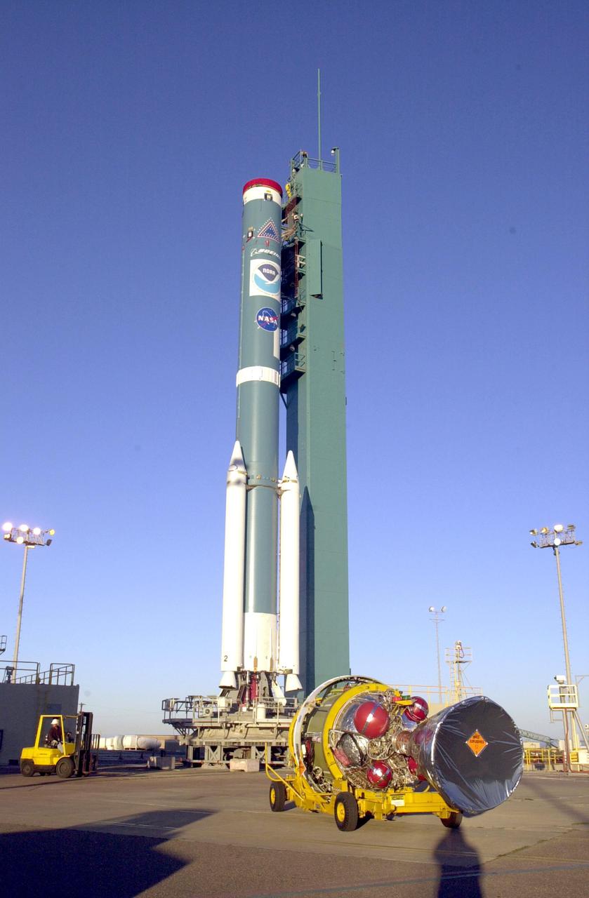 VANDENBERG AIR FORCE BASE, CALIF. - The second stage of the Boeing Delta II rocket, in the background, arrives at Space Launch Complex 2 on Vandenberg Air Force Base in California. It will be mated with the first stage. The Delta II is the launch vehicle for the National Oceanic and Atmospheric Administration (NOAA-N) spacecraft. After launch, NOAA-N will be renamed NOAA-18 and will provide measurements of the Earth's surface and atmosphere that will be entered into NOAA’s weather forecasting models and used for other environmental studies. Each day, the satellite will send data to NOAA’s Command and Data Acquisition station computers, adding vital information to forecasting models, especially over the oceans, where conventional data is lacking. Launch of NOAA-N is scheduled for May 11, 2005.