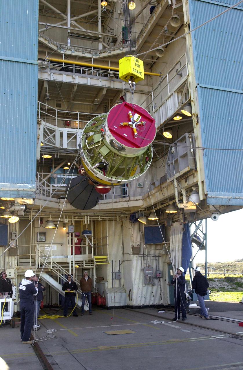 VANDENBERG AIR FORCE BASE, CALIF. -  At Space Launch Complex 2 on Vandenberg Air Force Base in California, Boeing workers help guide the second stage of the Boeing Delta II rocket to a vertical position.  The second stage will be lifted and mated with the first stage.  The Delta II will launch the National Oceanic and Atmospheric Administration (NOAA-N) spacecraft.   After launch, NOAA-N will be renamed NOAA-18 and will provide measurements of the Earth's surface and atmosphere that will be entered into NOAA’s weather forecasting models and used for other environmental studies. Each day, the satellite will send data to NOAA’s Command and Data Acquisition station computers, adding vital information to forecasting models, especially over the oceans, where conventional data is lacking.  Launch of NOAA-N is scheduled for May 11, 2005.
