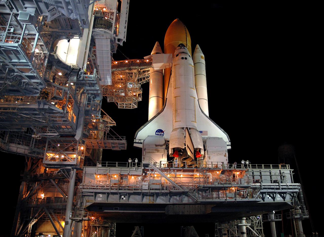 KENNEDY SPACE CENTER, FLA. -- The Rotating Service Structure is rolled back at Launch Pad 39B revealing Space Shuttle Discovery.  A propellant-loading test of Discovery's External Tank (ET) is scheduled for April 14. During the test, the tank will be filled to launch levels with ultra-cold hydrogen and oxygen propellants, known as 'cryogenics.' The test is designed to evaluate how the tank, orbiter, Solid Rocket Boosters and ground systems are performing under full 'cryo-load.' Throughout testing, engineers will observe the effectiveness of key safety modifications made to the External Tank. NASA’s Return to Flight mission, STS-114 on Space Shuttle Discovery, is targeted for launch on May 15 with a launch window that extends to June 3.