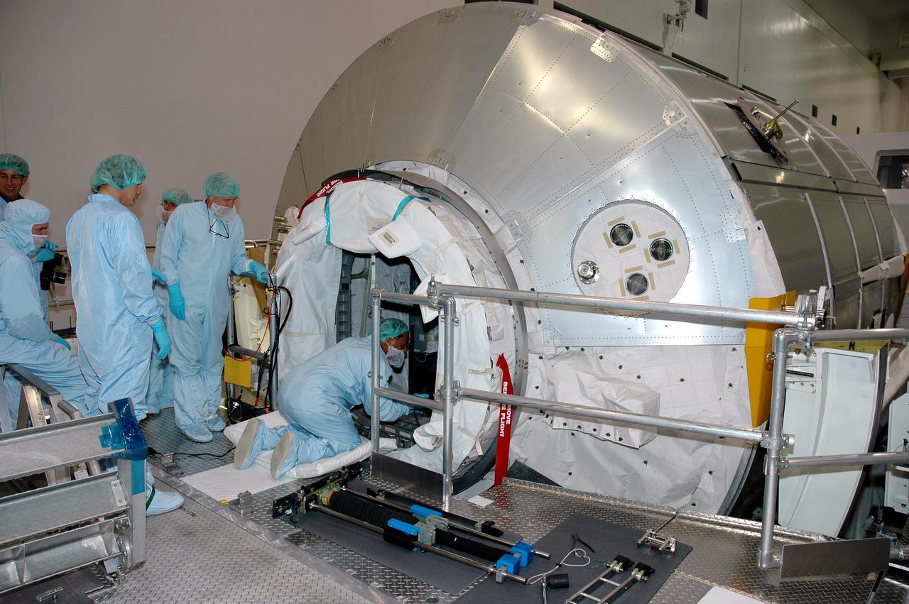KENNEDY SPACE CENTER, FLA. -- Workers in the Space Station Processing Facility prepare to close the hatch for flight on Italian-built Multi-Purpose Logistics Module Raffaello,  a significant milestone on the road to Return to Flight.  The module will travel to the International Space Station aboard Space Shuttle Discovery’s Return to Flight mission STS-114.  Raffaello carries 12 racks of cargo, including food, clothing, spare parts and research equipment, to the Station.  Shuttle Discovery is targeted for launch in a window extending May 15 through June 3.