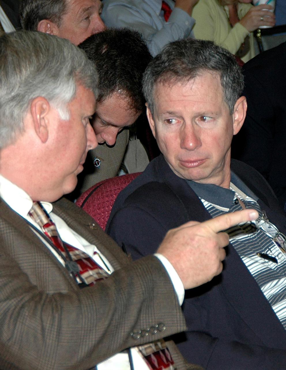KENNEDY SPACE CENTER, FLA.  -  NASA Administrator Michael Griffin listens as Jim Kennedy, Kennedy Space Center Director, briefs him on activities during the Space Shuttle Program’s Design Certification Review meeting held today.  Griffin was at KSC to attend the review in which Space Shuttle program managers reviewed changes and upgrades to the orbiter fleet in order to certify them for future Space Shuttle launches.