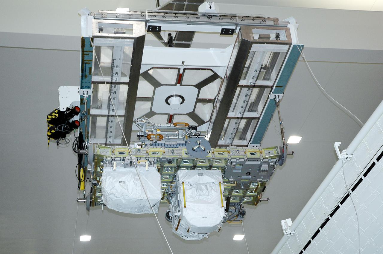 KENNEDY SPACE CENTER, FLA. - In the Space Station Processing Facility, the CELA (Cargo Element Lifting Assembly) moves the External Stowage Platform-2 launching aboard Space Shuttle Discovery on Return to Flight mission STS-114 to the payload canister. The ESP-2 will travel to Launch Pad 39B with its fellow payload elements the Lightweight MPESS Carrier (Multi-Purpose Experiment Support Structure) and Multi-Purpose Logistics Module Raffaello in the canister. Once at the pad, the three payloads will be transferred to the payload bay of Discovery for flight. The ESP-2 is carrying replacement parts to the International Space Station. The platform will be deployed and attached to the Station’s airlock and used as a permanent spare parts facility. STS-114 is targeted for launch during a window that extends from May 15 through June 3.