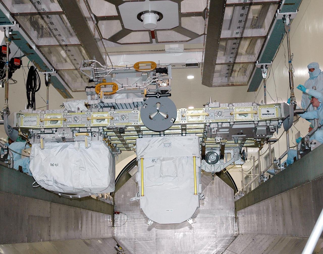 KENNEDY SPACE CENTER, FLA. - In the Space Station Processing Facility, the CELA (Cargo Element Lifting Assembly) lowers the External Stowage Platform-2 (ESP-2) into the payload canister. The ESP-2 will travel to Launch Pad 39B with its fellow payload elements the Lightweight MPESS Carrier (Multi-Purpose Experiment Support Structure) and Multi-Purpose Logistics Module Raffaello in the canister. Once at the pad, the three payloads will be transferred to the payload bay of Discovery for flight. The ESP-2 is carrying replacement parts to the International Space Station. The platform will be deployed and attached to the Station’s airlock and used as a permanent spare parts facility. STS-114 is targeted for launch during a window that extends from May 15 through June 3.