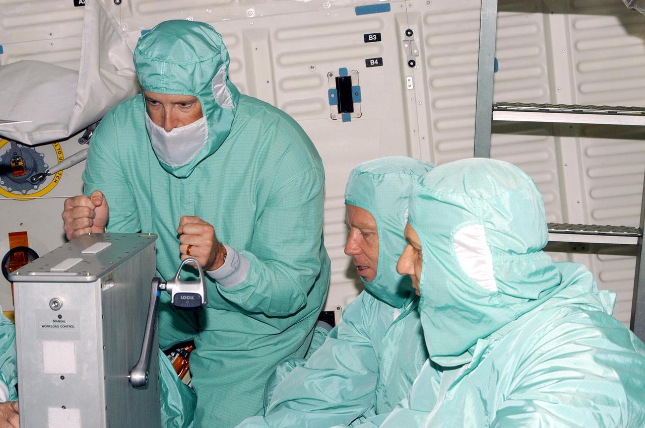 KENNEDY SPACE CENTER, FLA. - During Crew Equipment Interface Test (CEIT) at NASA’s Kennedy Space Center, STS-121 crew members are testing the ergometer that will be used for exercising while in space. Seen in the photo are Mission Specialists Michael E. Fossum (left) and Piers J. Sellers. STS-121 is the second Return to Flight mission to the International Space Station. During CEIT, the crew has an opportunity to get a hands-on look at the orbiter and equipment they will be working with on their mission. Mission STS-121 is scheduled to launch aboard Space Shuttle Atlantis in July.