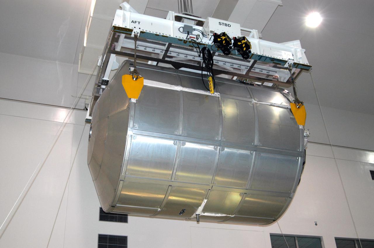 KENNEDY SPACE CENTER, FLA. - In the Space Station Processing Facility, the Multi-Purpose Logistics Module Raffaello moves across the floor to the Payload Transportation Canister for installation and transfer to Launch Pad 39-B.   Raffaello will travel aboard Space Shuttle Discovery on Return to Flight Mission STS-114 to the International Space Station.  Raffaello will carry 12 racks of cargo to the Station, including food, clothing, spare parts and research equipment.  The Boeing Company,  a KSC and NASA prime contractor for ISS element processing, prepared Raffaello for flight.  The module was built by the Italian Space Agency for NASA under a cooperative space agreement.