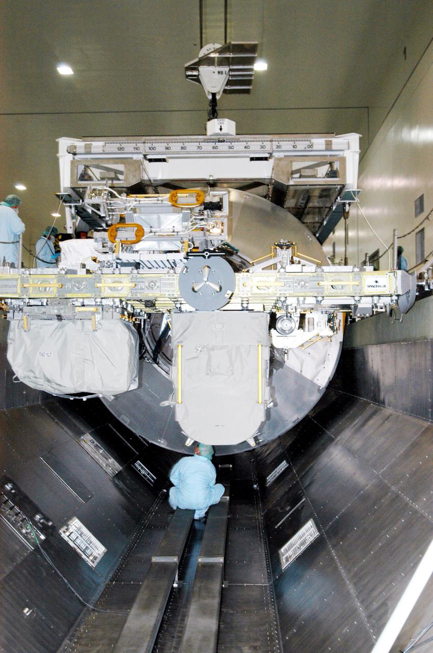 KENNEDY SPACE CENTER, FLA. - In the Space Station Processing Facility, engineers install the Multi-Purpose Logistics Module Raffaello in the Payload Transportation Canister.  It rests behind the External Stowage Platform-2.   The canister will transfer the payloads to Launch Pad 39-B.  Raffaello will travel aboard Space Shuttle Discovery on Return to Flight Mission STS-114 to the International Space Station.  Raffaello will carry 12 racks of cargo to the Station, including food, clothing, spare parts and research equipment.  The Boeing Company,  a KSC and NASA prime contractor for ISS element processing, prepared Raffaello for flight.  The module was built by the Italian Space Agency for NASA under a cooperative space agreement.