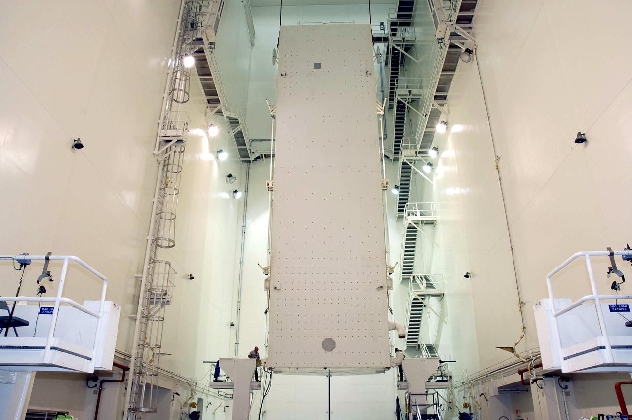 KENNEDY SPACE CENTER, FLA. - In the Canister Rotation Facility at NASA’s Kennedy Space Center, the Payload Canister is being raised to a vertical position for transport to Launch Pad 39B. The payloads inside, including the Multi-Purpose Logistics Module Raffaello and External Stowage Platform-2, will be moved into the Payload Changeout Room in the Rotating Service Structure and then installed in Discovery’s payload bay. Space Shuttle Discovery is scheduled to launch on Return to Flight mission STS-114 to the International Space Station. The launch window extends from May 22 to June 3.