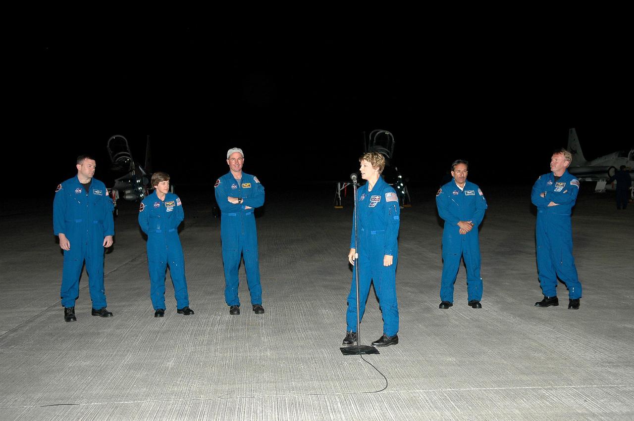 KENNEDY SPACE CENTER, FLA. - After arrival at NASA’s Kennedy Space Center, the STS-114 crew members pause on the runway while Commander Eileen Collins makes a brief statement to the media. Standing behind her, from left, are Pilot James Kelly and Mission Specialists Wendy Lawrence, Stephen Robinson, Charles Camarda, and Andrew Thomas. The crew is at KSC to take part in the Terminal Countdown Demonstration Test (TCDT) over the next three days. The TCDT is held at KSC prior to each Space Shuttle flight. It provides the crew of each mission an opportunity to participate in simulated countdown activities. The test ends with a mock launch countdown culminating in a simulated main engine cutoff. The crew also spends time undergoing emergency egress training exercises at the launch pad. STS-114 is the first Return to Flight mission to the International Space Station. The launch window extends July 13 through July 31.