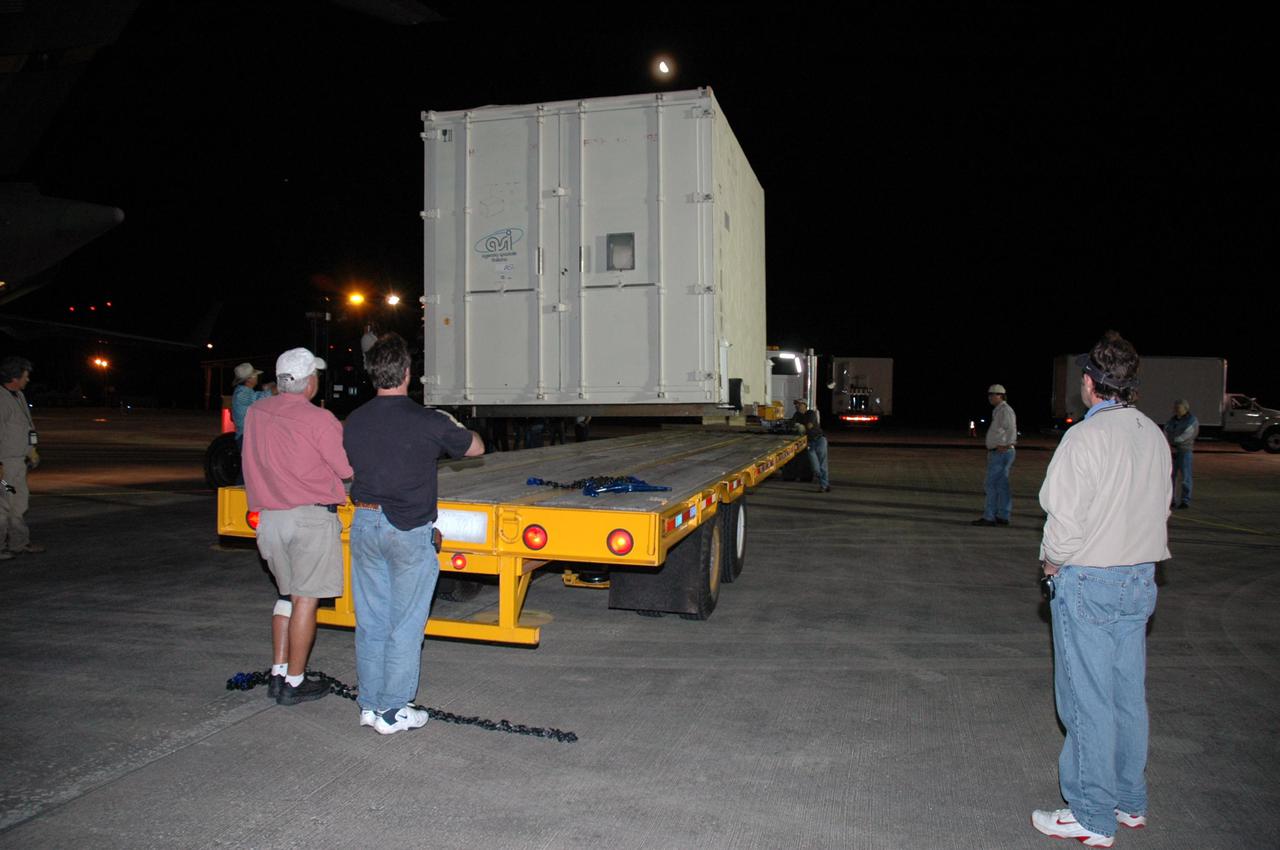 KENNEDY SPACE CENTER, FLA. - At Kennedy Space Center's Shuttle Landing Facility, the second of two containers with the Mars Reconnaissance Orbiter (MRO) equipment is lifted onto a flatbed truck for transport to the Payload Hazardous Servicing Facility. The MRO was built by Lockheed Martin for NASA's Jet Propulsion Laboratory in California. It is the next major step in Mars exploration and scheduled for launch from Cape Canaveral Air Force Station in a window opening Aug. 10. The MRO carries six primary instruments: the High Resolution Imaging Science Experiment, Context Camera, Mars Color Imager, Compact Reconnaissance Imaging Spectrometer for Mars, Mars Climate Sounder and Shallow Radar. By 2007, the MRO will begin a series of global mapping, regional survey and targeted observations from a near-polar, low-altitude Mars orbit. It will observe the atmosphere and surface of Mars while probing its shallow subsurface as part of a “follow the water” strategy.