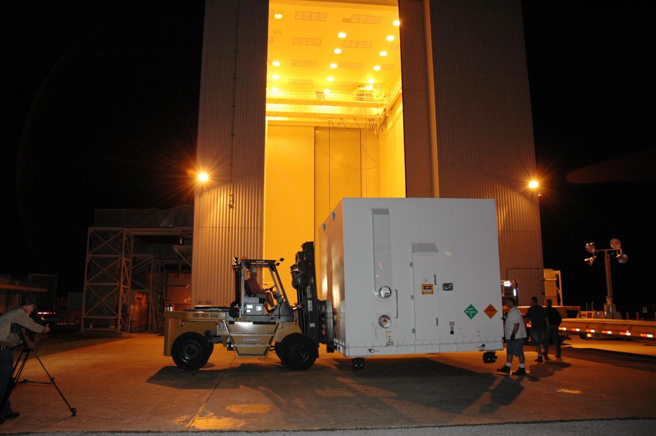 KENNEDY SPACE CENTER, FLA. - One of two containers with the Mars Reconnaissance Orbiter (MRO) equipment arrives at the Payload Hazardous Servicing Facility. The MRO was built by Lockheed Martin for NASA's Jet Propulsion Laboratory in California. It is the next major step in Mars exploration and scheduled for launch from Cape Canaveral Air Force Station in a window opening Aug. 10. The MRO carries six primary instruments: the High Resolution Imaging Science Experiment, Context Camera, Mars Color Imager, Compact Reconnaissance Imaging Spectrometer for Mars, Mars Climate Sounder and Shallow Radar. By 2007, the MRO will begin a series of global mapping, regional survey and targeted observations from a near-polar, low-altitude Mars orbit. It will observe the atmosphere and surface of Mars while probing its shallow subsurface as part of a “follow the water” strategy.