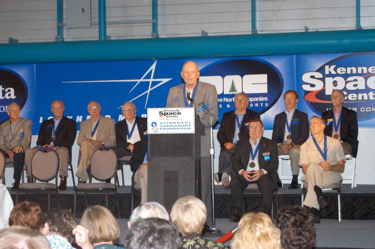 KENNEDY SPACE CENTER, FLA. -  At the Astronaut Hall of Fame Induction Ceremony, new inductee Gordon Fullerton addresses guests.  Behind him are current Hall of Famers (from left, back row) Al Worden, Charles Duke, Jack Lousma, Bill Pogue, Dan Brandenstein, Robert “Hoot” Gibson and Stephen Covey; (in front row) Fred Haise and Vance Brand.  The other new inductees are Bruce McCandless and Joe Allen.  The event is being held in the Kennedy Space Center Visitor Complex’s Apollo_Saturn V Center. Recognized for their individual flight accomplishments and contributions to the success and future success of the U.S. space program, this elite group of inductees is among only 60 astronauts to be honored in the Hall of Fame and the fourth group of Space Shuttle astronauts named.