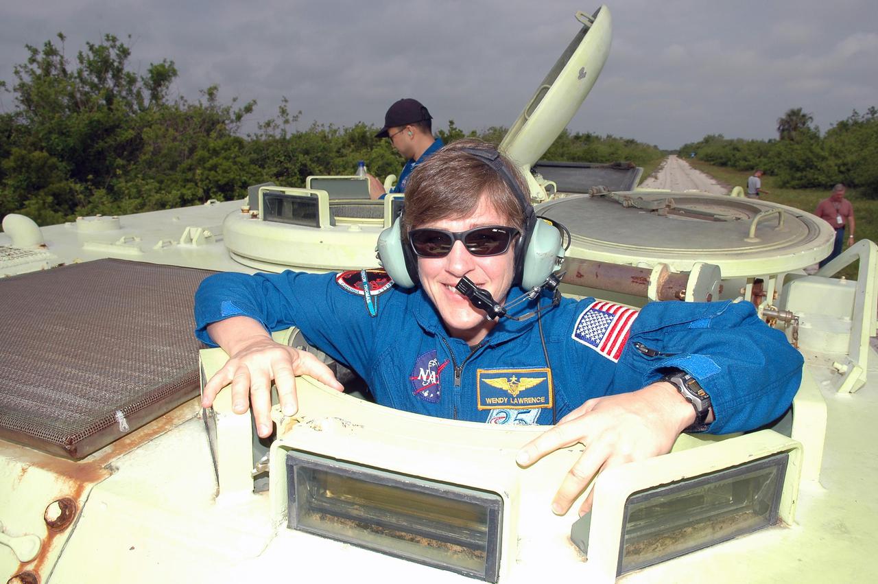 KENNEDY SPACE CENTER, FLA. - During Terminal Countdown Demonstration Test (TCDT) activities at NASA’s Kennedy Space Center, the STS-114 Mission Specialist Wendy Lawrence is getting ready to practice driving an M-113, an armored personnel carrier that is used for speedy departure from the launch pad in an emergency. The TCDT is held at KSC prior to each Space Shuttle flight. It provides the crew of each mission an opportunity to participate in simulated countdown activities. The test ends with a mock launch countdown culminating in a simulated main engine cutoff. The crew also spends time undergoing emergency egress training exercises at the launch pad. STS-114 is the first Return to Flight mission to the International Space Station. The launch window extends July 13 through July 31.