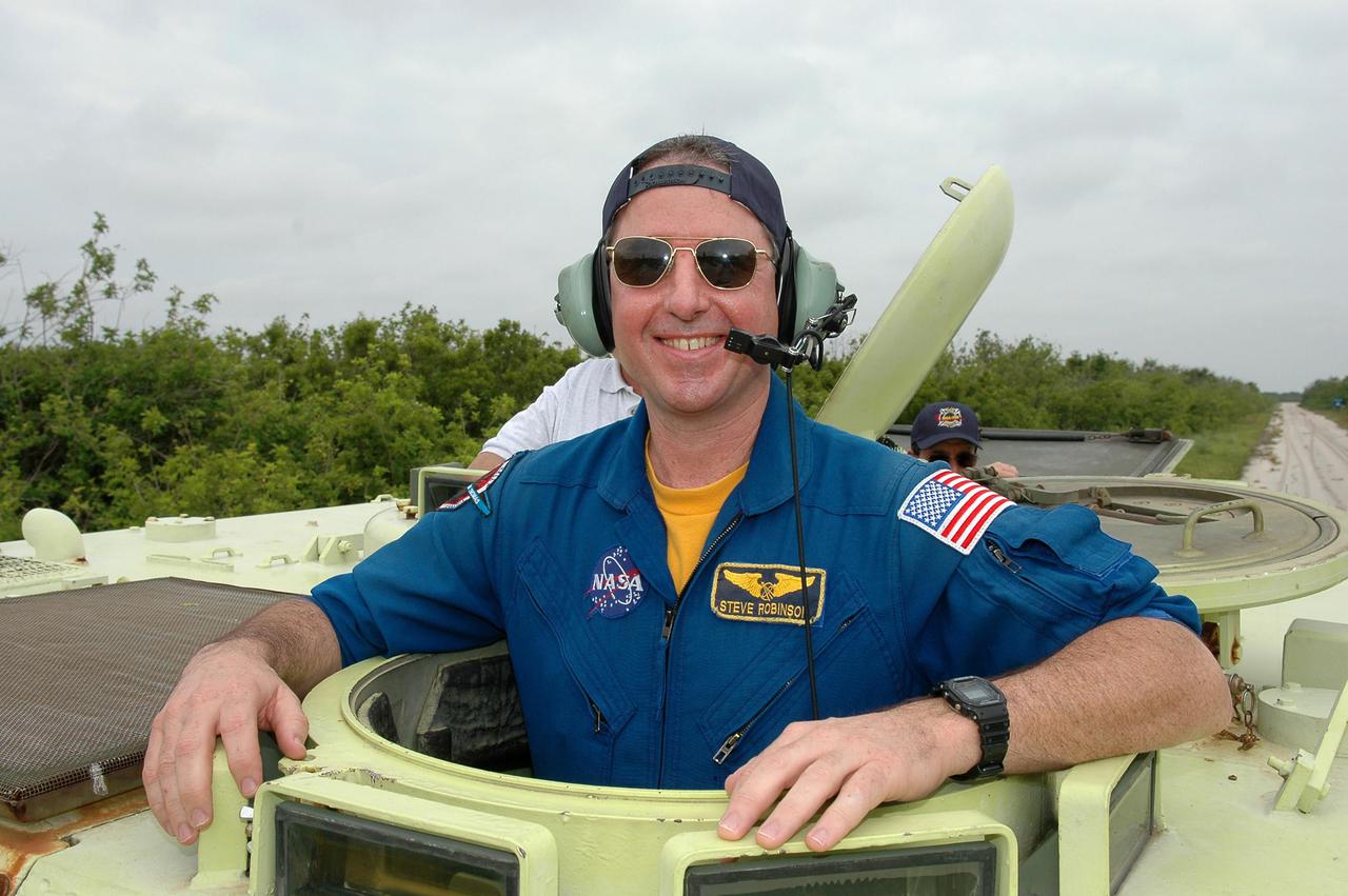 KENNEDY SPACE CENTER, FLA. - During Terminal Countdown Demonstration Test (TCDT) activities at NASA’s Kennedy Space Center, STS-114 Mission Specialist Stephen Robinson is getting ready to practice driving an M-113, an armored personnel carrier that is used for speedy departure from the launch pad in an emergency. The TCDT is held at KSC prior to each Space Shuttle flight. It provides the crew of each mission an opportunity to participate in simulated countdown activities. The test ends with a mock launch countdown culminating in a simulated main engine cutoff. The crew also spends time undergoing emergency egress training exercises at the launch pad. STS-114 is the first Return to Flight mission to the International Space Station. The launch window extends July 13 through July 31.