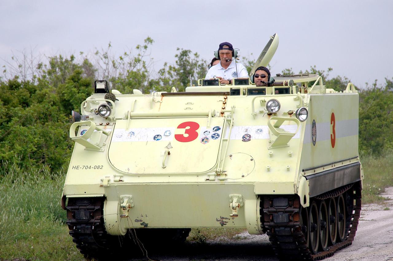 KENNEDY SPACE CENTER, FLA. - During Terminal Countdown Demonstration Test (TCDT) activities at NASA’s Kennedy Space Center, STS-114 Mission Specialist Soichi Noguchi drives an M-113, an armored personnel carrier that is used for speedy departure from the launch pad in an emergency. Behind him at left is Capt. George Hoggard, who is astronaut rescue team leader. Noguchi is with the Japan Aerospace Exploration Agency. The TCDT is held at KSC prior to each Space Shuttle flight. It provides the crew of each mission an opportunity to participate in simulated countdown activities. The test ends with a mock launch countdown culminating in a simulated main engine cutoff. The crew also spends time undergoing emergency egress training exercises at the launch pad. STS-114 is the first Return to Flight mission to the International Space Station. The launch window extends July 13 through July 31.