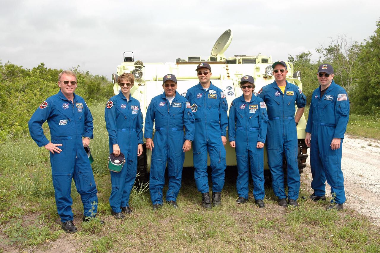 KENNEDY SPACE CENTER, FLA. - During Terminal Countdown Demonstration Test (TCDT) activities at NASA’s Kennedy Space Center, the STS-114 crew pauses during M-113 training at the launch pad. From left are Mission Specialist Andrew Thomas, Commander Eileen Collins, Mission Specialists Charles Camarda, Soichi Noguchi, Wendy Lawrence and Stephen Robinson, and Pilot James Kelly. The TCDT is held at KSC prior to each Space Shuttle flight. It provides the crew of each mission an opportunity to participate in simulated countdown activities. The test ends with a mock launch countdown culminating in a simulated main engine cutoff. The crew also spends time undergoing emergency egress training exercises at the launch pad. STS-114 is the first Return to Flight mission to the International Space Station. The launch window extends July 13 through July 31.