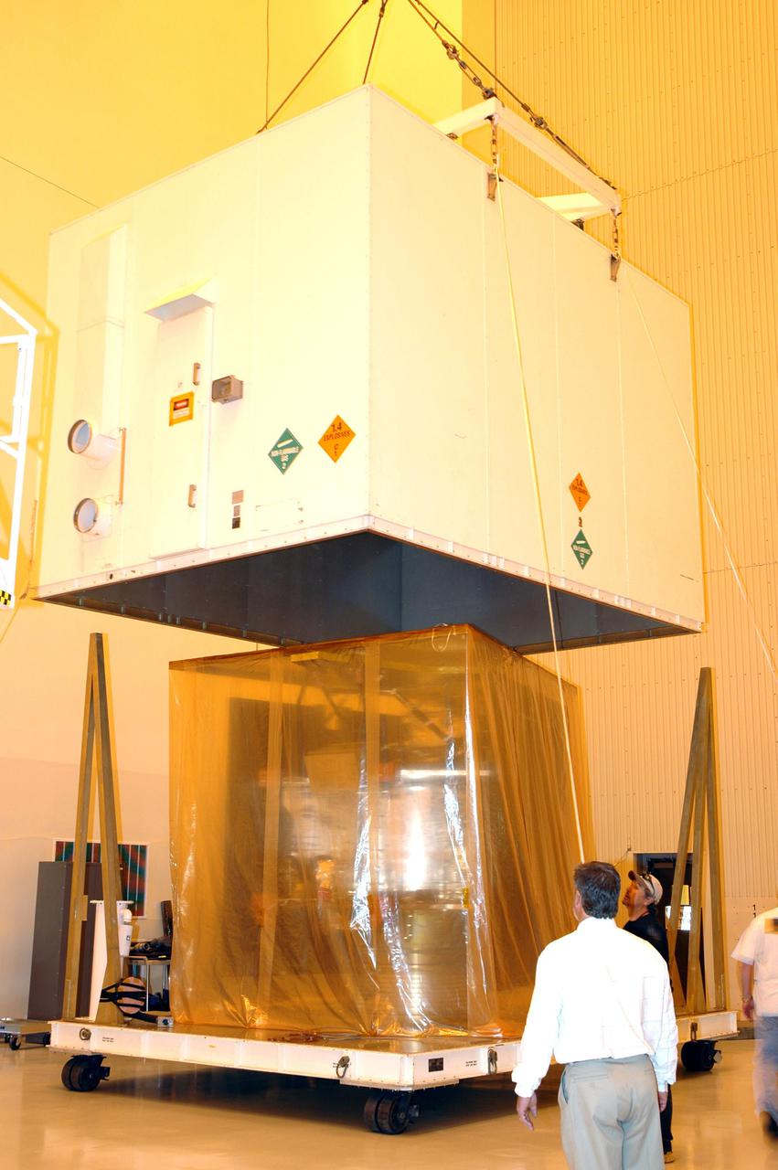 KENNEDY SPACE CENTER, FLA. - Inside the Payload Hazardous Servicing Facility (PHSF) at NASA's Kennedy Space Center, the cover is removed from one of the boxes containing NASA's Mars Reconnaissance Orbiter. Here in the PHSF, the spacecraft will undergo multiple mechanical assembly operations and electrical tests to verify its readiness for launch. A test this month will verify the spacecraft's ability to communicate through NASA's Deep Space Network tracking stations. A June test will check the deployment of the spacecraft's high gain communications antenna. Another major deployment test will check out the spacecraft's large solar arrays. The MRO was built by Lockheed Martin for NASA's Jet Propulsion Laboratory in California. It is the next major step in Mars exploration and scheduled for launch from Cape Canaveral Air Force Station in a window opening Aug. 10. The MRO is an important next step in fulfilling NASA's vision of space exploration and ultimately sending human explorers to Mars and beyond.