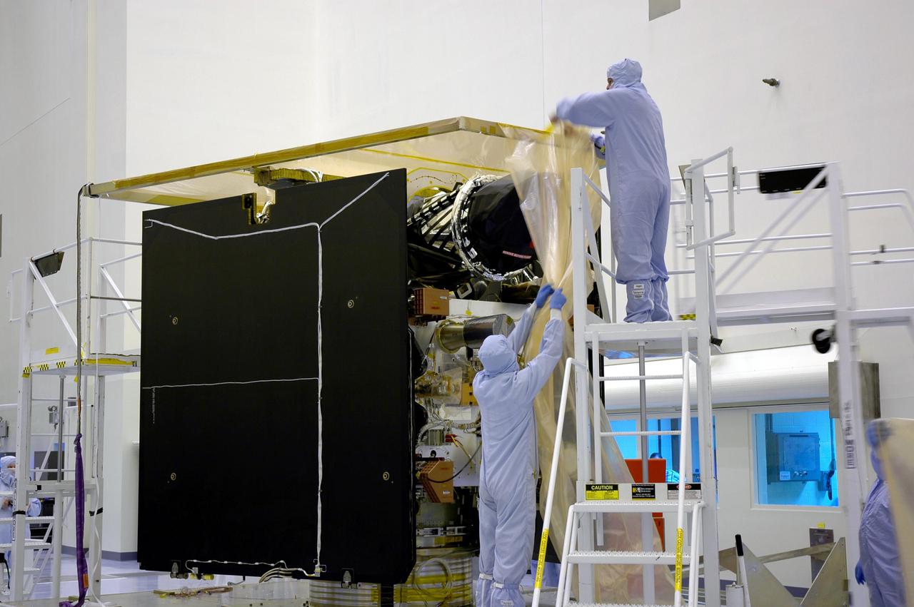 KENNEDY SPACE CENTER, FLA. - In a clean room inside the Payload Hazardous Servicing Facility (PHSF) at NASA's Kennedy Space Center, removal of the protective cover reveals some of the hardware for NASA's Mars Reconnaissance Orbiter. Here in the PHSF, the spacecraft will undergo multiple mechanical assembly operations and electrical tests to verify its readiness for launch. A test this month will verify the spacecraft's ability to communicate through NASA's Deep Space Network tracking stations. A June test will check the deployment of the spacecraft's high gain communications antenna. Another major deployment test will check out the spacecraft's large solar arrays. The MRO was built by Lockheed Martin for NASA's Jet Propulsion Laboratory in California. It is the next major step in Mars exploration and scheduled for launch from Cape Canaveral Air Force Station in a window opening Aug. 10. The MRO is an important next step in fulfilling NASA's vision of space exploration and ultimately sending human explorers to Mars and beyond.