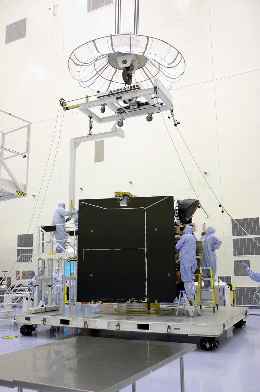 KENNEDY SPACE CENTER, FLA. - In a clean room inside the Payload Hazardous Servicing Facility (PHSF) at NASA's Kennedy Space Center,  an overhead crane has moved into position over the Lockheed Martin-built Mars Reconnaissance Orbiter (MRO).  The crane will lift the spacecraft and move it to a nearby workstand for final assembly and testing.  In the PHSF, the spacecraft will undergo multiple mechanical assembly operations and electrical tests to verify its readiness for launch. A test this month will verify the spacecraft's ability to communicate through NASA's Deep Space Network tracking stations. A June test will check the deployment of the spacecraft's high gain communications antenna. Another major deployment test will check out the spacecraft's large solar arrays.  The MRO was built for NASA's Jet Propulsion Laboratory in California.  It is the next major step in Mars exploration and scheduled for launch from Cape Canaveral Air Force Station in a window opening Aug. 10. The MRO is an important next step in fulfilling NASA's vision of space exploration and ultimately sending human explorers to Mars and beyond.
