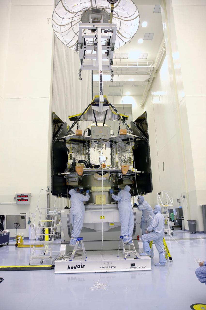 KENNEDY SPACE CENTER, FLA. - In a clean room inside the Payload Hazardous Servicing Facility (PHSF) at NASA's Kennedy Space Center, Lockheed Martin workers assure the Mars Reconnaissance Orbiter is secure on its workstand for final assembly and testing. In the PHSF, the spacecraft will undergo multiple mechanical assembly operations and electrical tests to verify its readiness for launch. A test this month will verify the spacecraft's ability to communicate through NASA's Deep Space Network tracking stations. A June test will check the deployment of the spacecraft's high gain communications antenna. Another major deployment test will check out the spacecraft's large solar arrays. The MRO was built for NASA's Jet Propulsion Laboratory in California. It is the next major step in Mars exploration and scheduled for launch from Cape Canaveral Air Force Station in a window opening Aug. 10. The MRO is an important next step in fulfilling NASA's vision of space exploration and ultimately sending human explorers to Mars and beyond.