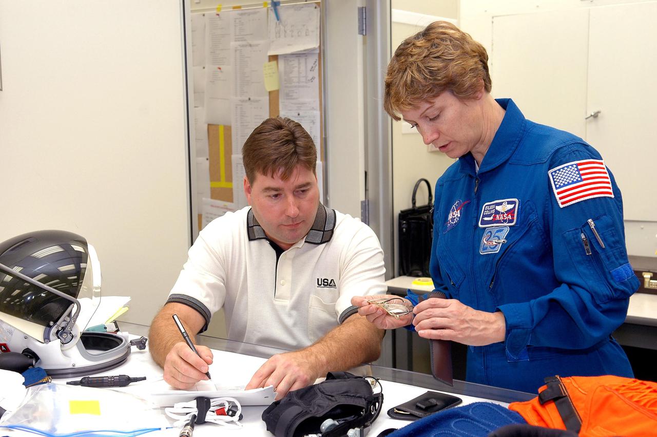 KENNEDY SPACE CENTER, FLA. - As part of pre-pack and fit check for Terminal Countdown Demonstration Test (TCDT) activities, STS-114 Commander Eileen Collins examines glasses that will be on the flight. The TCDT is held at KSC prior to each Space Shuttle flight. It provides the crew of each mission an opportunity to participate in simulated countdown activities. The test ends with a mock launch countdown culminating in a simulated main engine cutoff. The crew also spends time undergoing emergency egress training exercises at the launch pad. STS-114 is the first Return to Flight mission to the International Space Station. The launch window extends July 13 through July 31.