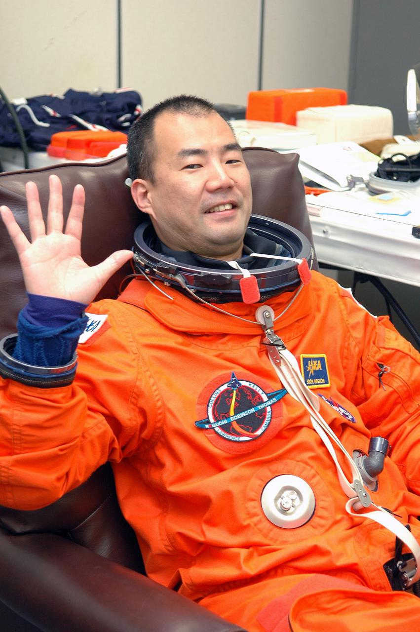 KENNEDY SPACE CENTER, FLA. - As part of pre-pack and fit check for Terminal Countdown Demonstration Test (TCDT) activities, STS-114 Mission Specialist Soichi Noguchi tries on his launch suit. The TCDT is held at KSC prior to each Space Shuttle flight. It provides the crew of each mission an opportunity to participate in simulated countdown activities. The test ends with a mock launch countdown culminating in a simulated main engine cutoff. The crew also spends time undergoing emergency egress training exercises at the launch pad. STS-114 is the first Return to Flight mission to the International Space Station. The launch window extends July 13 through July 31.