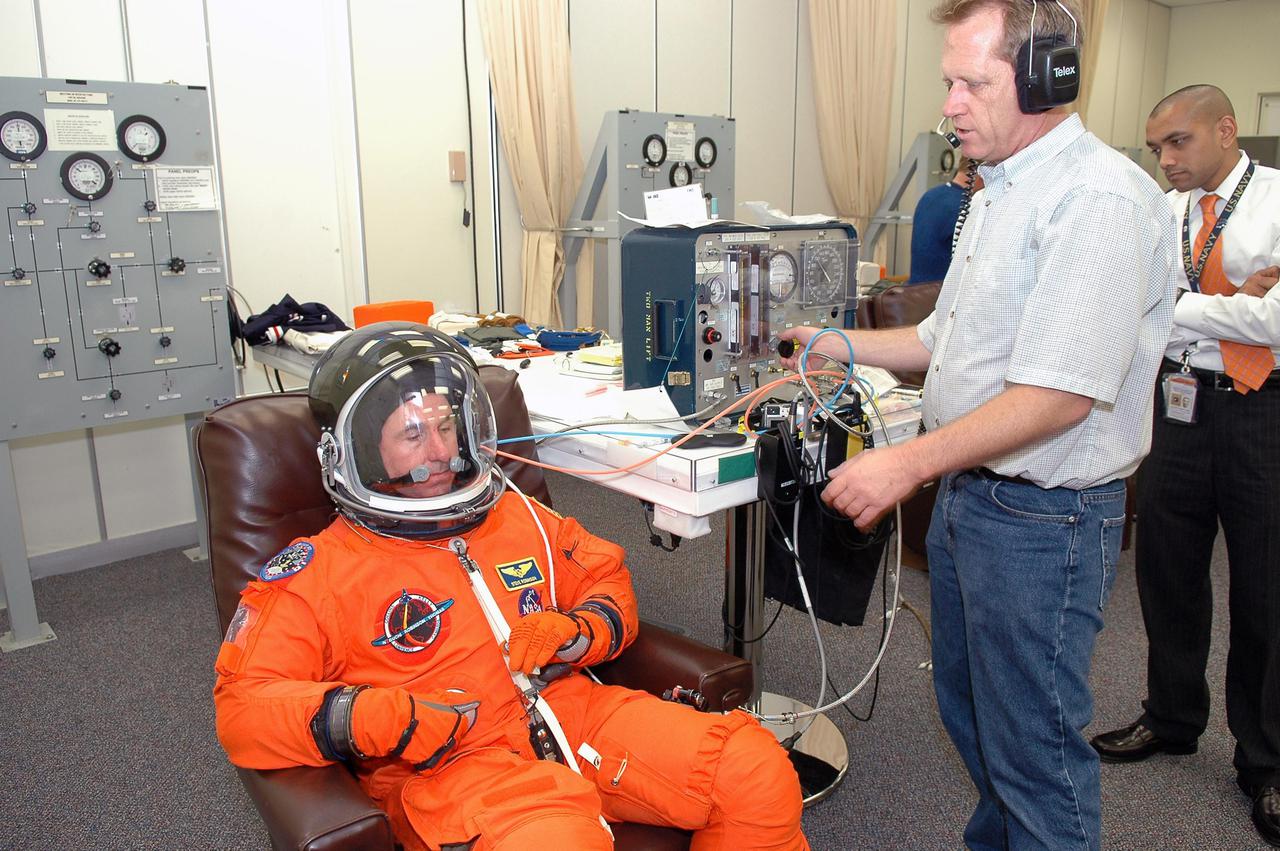 KENNEDY SPACE CENTER, FLA. - As part of pre-pack and fit check for Terminal Countdown Demonstration Test (TCDT) activities, STS-114 Mission Specialist Stephen Robinson has various elements of his launch suit and helmet checked. The TCDT is held at KSC prior to each Space Shuttle flight. It provides the crew of each mission an opportunity to participate in simulated countdown activities. The test ends with a mock launch countdown culminating in a simulated main engine cutoff. The crew also spends time undergoing emergency egress training exercises at the launch pad. STS-114 is the first Return to Flight mission to the International Space Station. The launch window extends July 13 through July 31.