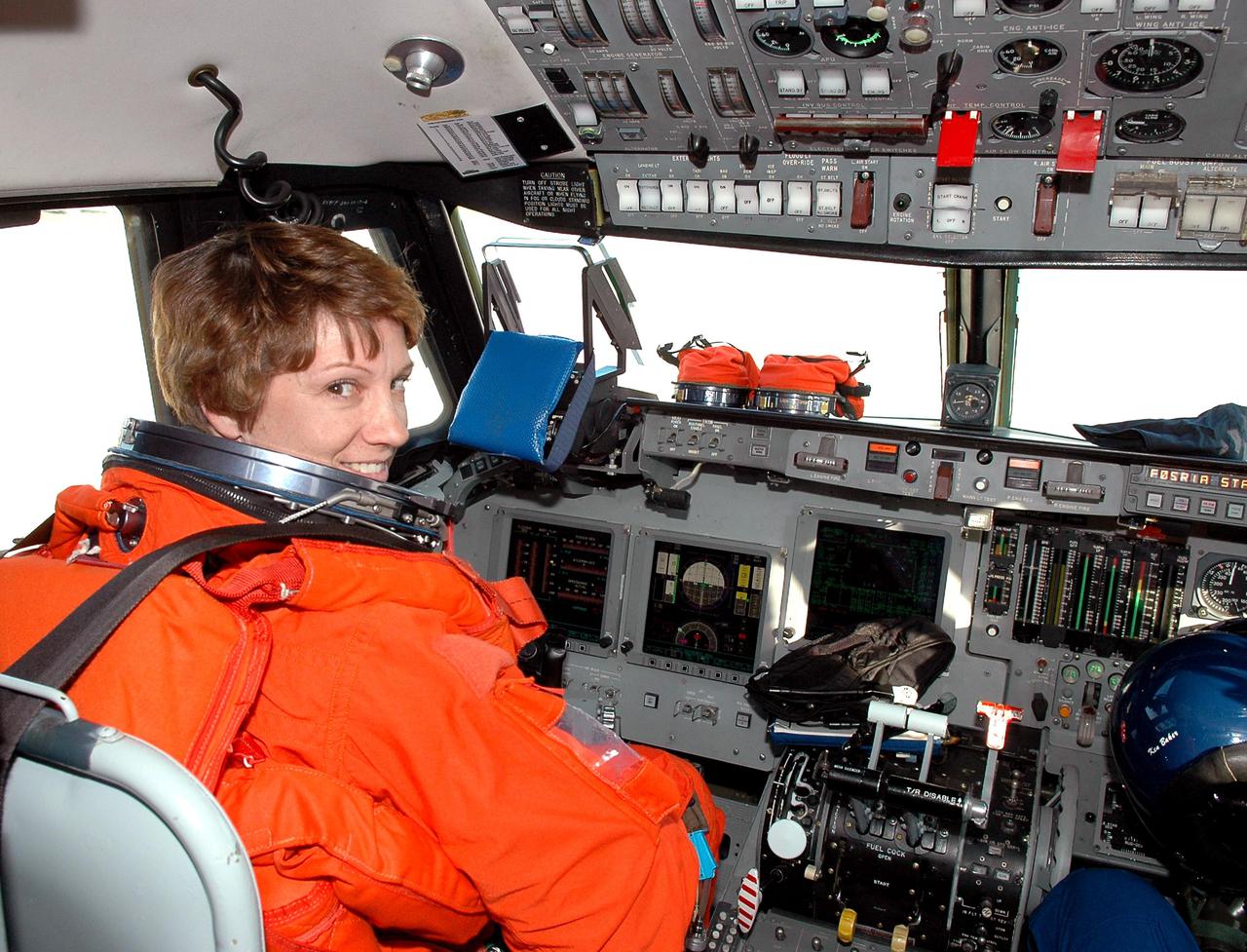 KENNEDY SPACE CENTER, FLA. -  STS-114 Commander Eileen Collins is strapped into the command seat of a Shuttle Training Aircraft (STA) to practice landing the orbiter.  The STA is a modified Grumman American Aviation-built Gulfstream II executive jet that was modified to simulate an orbiter’s cockpit, motion and visual cues, and handling qualities.  In flight, the STA duplicates the orbiter’s atmospheric descent trajectory from approximately 35,000 feet altitude to landing on a runway. The orbiter differs in at least one major aspect from conventional aircraft; it is unpowered during re-entry and landing so its high-speed glide must be perfectly executed the first time. There is no go-around capability. The orbiter touchdown speed is 213 to 226 miles per hour. There are two STAs, based in Houston. STS-114 is the first Return to Flight mission, scheduled to launch July 13 in a window that extends through July 31.