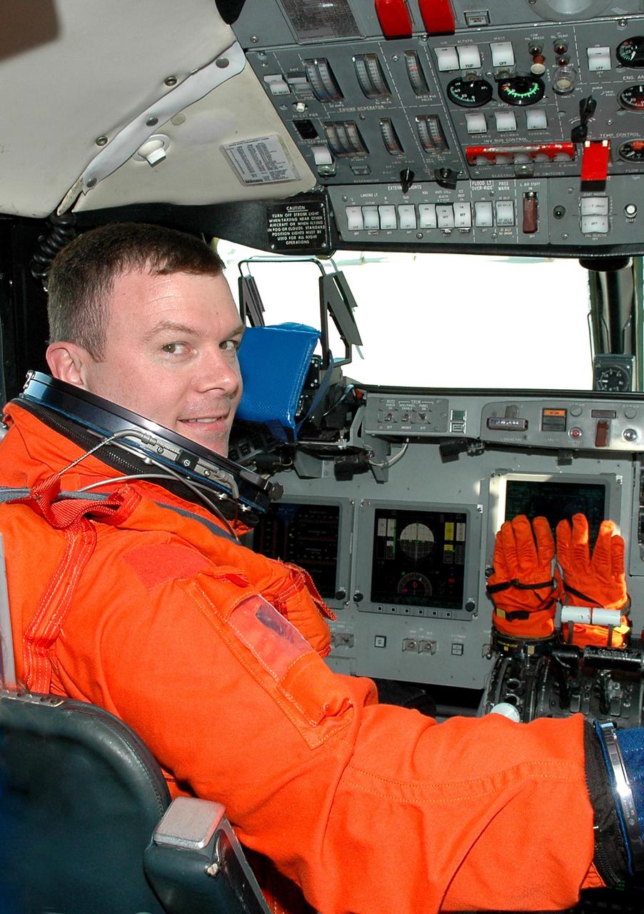 KENNEDY SPACE CENTER, FLA. -  STS-114 Pilot James Kelly settles into the command seat of a Shuttle Training Aircraft (STA) to practice landing the orbiter.  The STA is a modified Grumman American Aviation-built Gulfstream II executive jet that was modified to simulate an orbiter’s cockpit, motion and visual cues, and handling qualities.  In flight, the STA duplicates the orbiter’s atmospheric descent trajectory from approximately 35,000 feet altitude to landing on a runway. The orbiter differs in at least one major aspect from conventional aircraft; it is unpowered during re-entry and landing so its high-speed glide must be perfectly executed the first time. There is no go-around capability. The orbiter touchdown speed is 213 to 226 miles per hour. There are two STAs, based in Houston. STS-114 is the first Return to Flight mission, scheduled to launch July 13 in a window that extends through July 31.