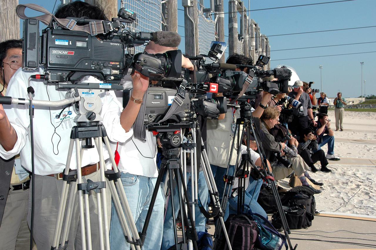 KENNEDY SPACE CENTER, FLA. - Dozens of media are gathered at the slidewire basket landing area on Launch Pad 39B to interview and hear comments from the STS-114 crew: Mission Specialists Andrew Thomas, Wendy Lawrence and Stephen Robinson, Commander Eileen Collins, Mission Specialists Charles Camarda and Soichi Noguchi, and Pilot James Kelly. Noguchi is with the Japan Aerospace Exploration Agency. The TCDT is held at KSC prior to each Space Shuttle flight. It provides the crew of each mission an opportunity to participate in simulated countdown activities. The test ends with a mock launch countdown culminating in a simulated main engine cutoff. The crew also spends time undergoing emergency egress training exercises at the launch pad. STS-114 is designated the first Return to Flight mission, with a launch window extending from July 13 to July 31.