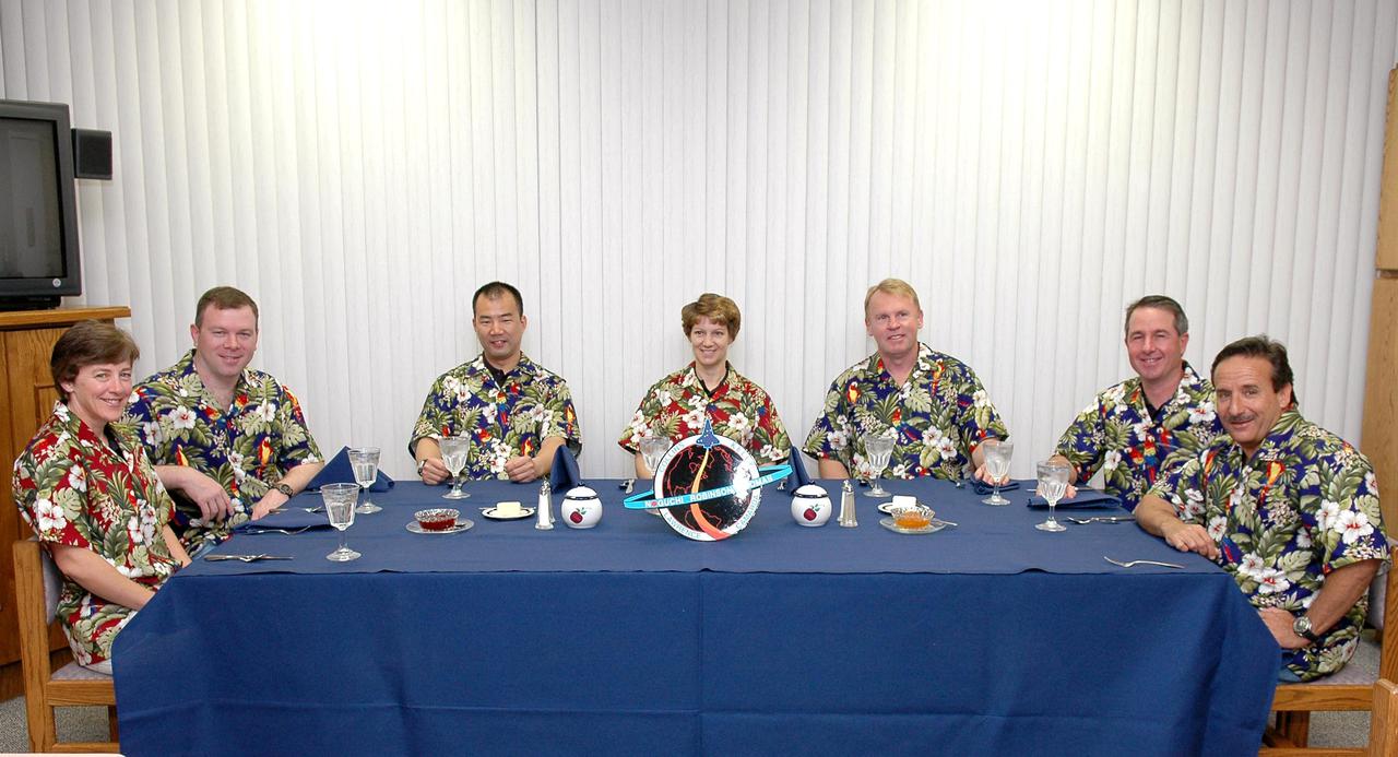 KENNEDY SPACE CENTER, FLA. - The STS-114 crew partakes of the traditional breakfast in the crew quarters at the Operations and Checkout (OandC) Building prior to suit-up for the trip to Launch Pad 39B for a mock launch countdown culminating in a simulated main engine cutoff. Seated, from left, are Mission Specialist Wendy Lawrence, Pilot James Kelly, Mission Specialist Soichi Noguchi, Commander Eileen Collins, and Mission Specialists Andrew Thomas, Stephen Robinson, and Charles Camarda. Noguchi is with the Japan Aerospace Exploration Agency. The dress rehearsal is part of Terminal Countdown Demonstration Test (TCDT) activities held prior to each Space Shuttle flight. It provides the crew of each mission an opportunity to participate in various simulated countdown activities, including equipment familiarization and emergency egress training. STS-114 is the first Return to Flight mission to the International Space Station. The launch window extends July 13 through July 31.