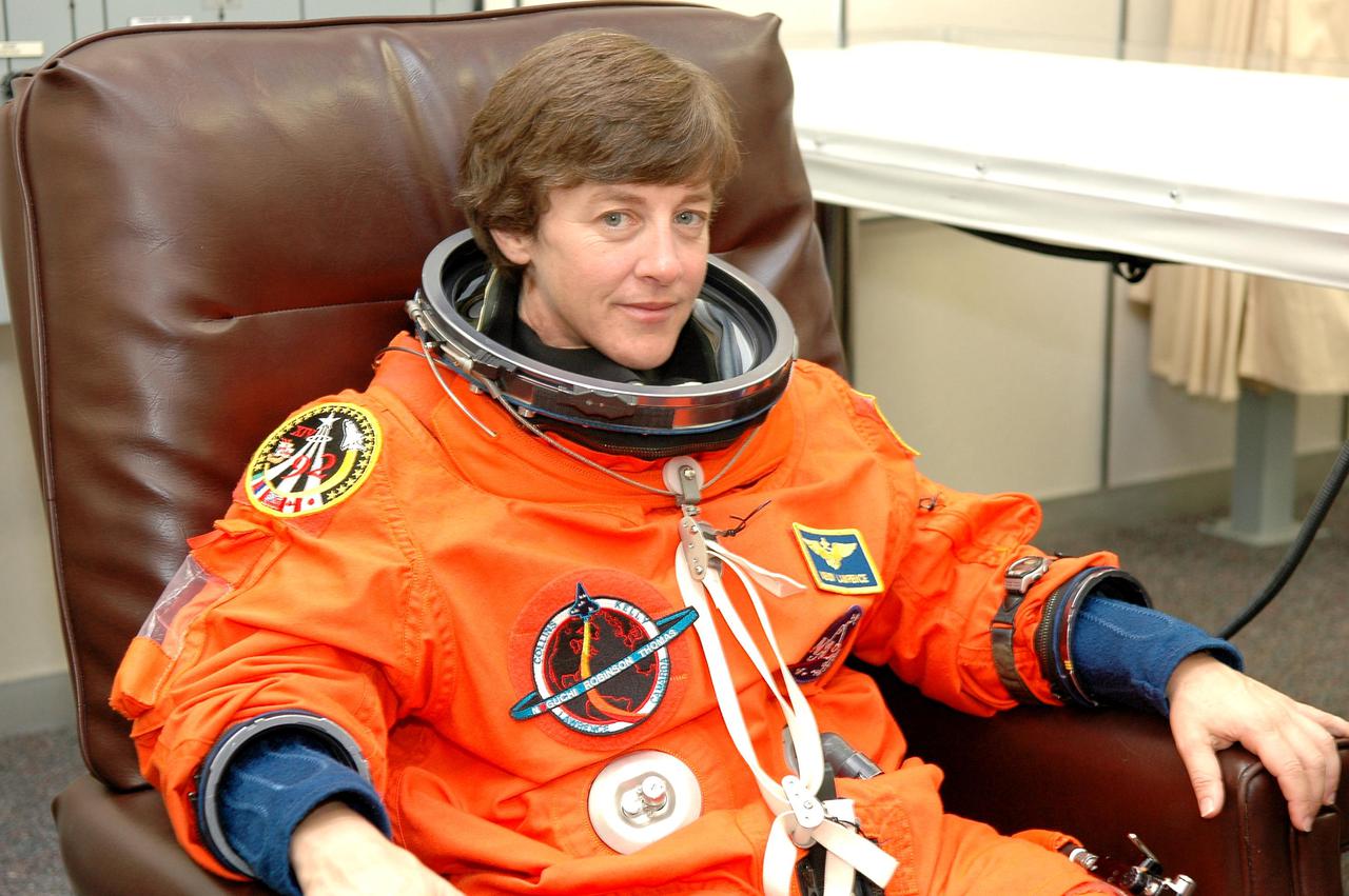 KENNEDY SPACE CENTER, FLA. -STS-114 Mission Specialist Wendy Lawrence suits up in the Operations and Checkout Building for the trip to Launch Pad 39B for a mock launch countdown culminating in a simulated main engine cutoff. The dress rehearsal is part of Terminal Countdown Demonstration Test (TCDT) activities held prior to each Space Shuttle flight. It provides the crew of each mission an opportunity to participate in various simulated countdown activities, including equipment familiarization and emergency egress training. STS-114 is the first Return to Flight mission to the International Space Station. The launch window extends July 13 through July 31.