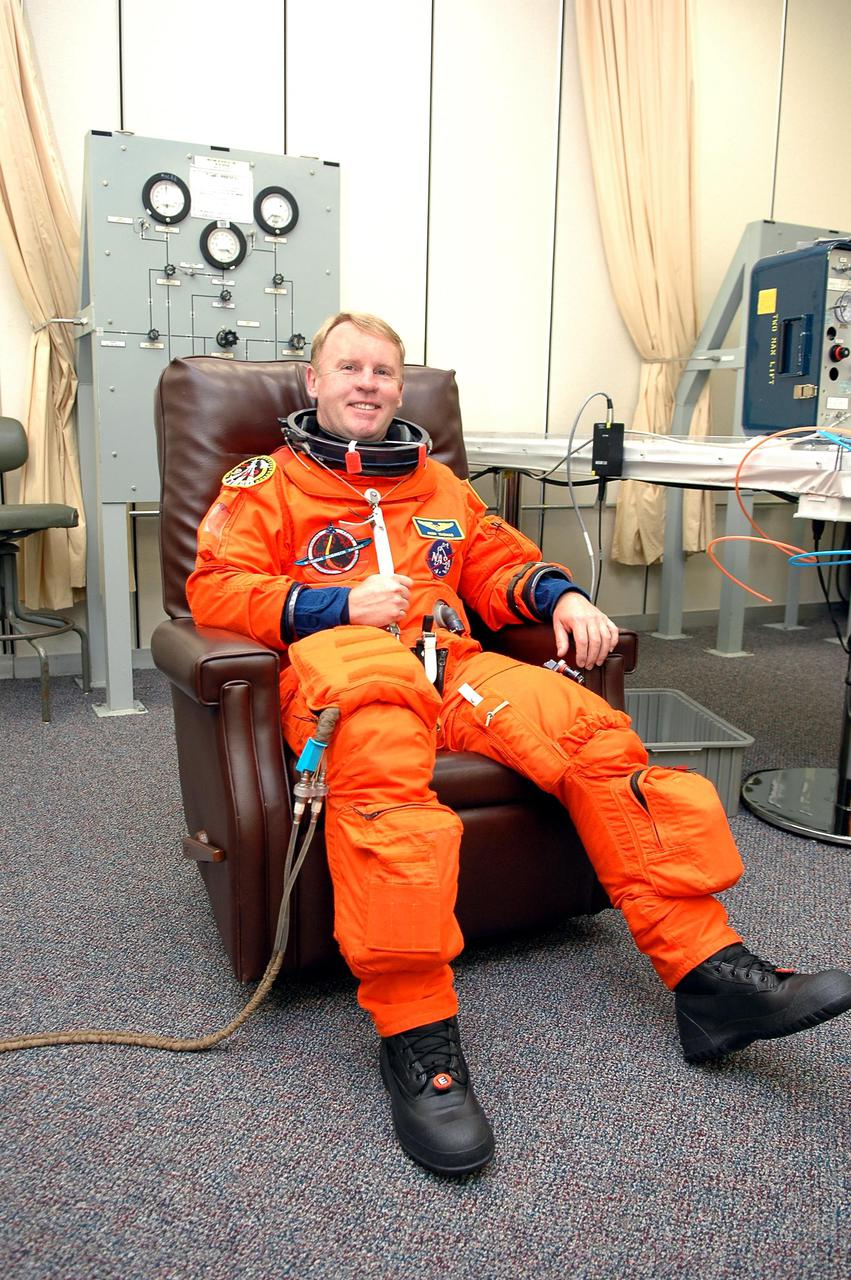 KENNEDY SPACE CENTER, FLA. -STS-114 Mission Specialist Andrew Thomas suits up in the Operations and Checkout Building for the trip to Launch Pad 39B for a mock launch countdown culminating in a simulated main engine cutoff. The dress rehearsal is part of Terminal Countdown Demonstration Test (TCDT) activities held prior to each Space Shuttle flight. It provides the crew of each mission an opportunity to participate in various simulated countdown activities, including equipment familiarization and emergency egress training. STS-114 is the first Return to Flight mission to the International Space Station. The launch window extends July 13 through July 31.