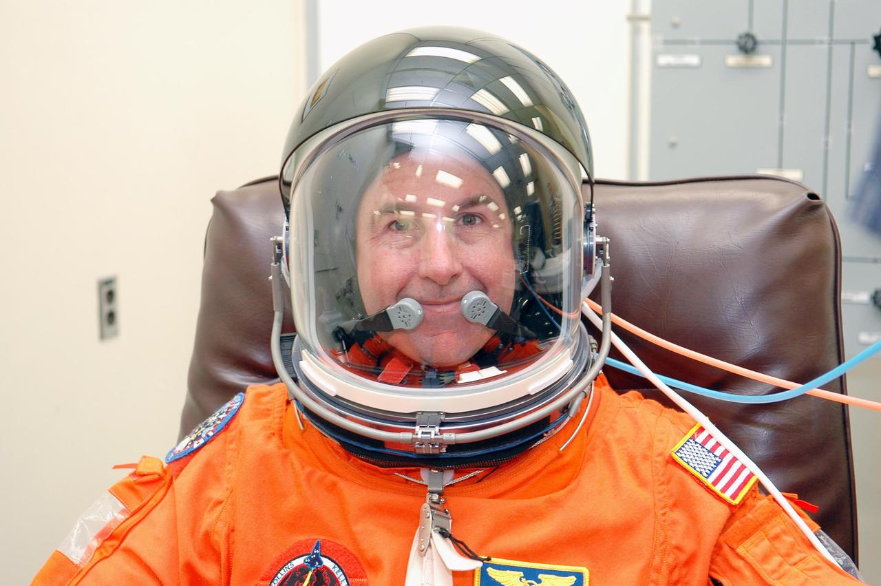 KENNEDY SPACE CENTER, FLA. -STS-114 Mission Specialist Stephen Robinson suits up in the Operations and Checkout Building for the trip to Launch Pad 39B for a mock launch countdown culminating in a simulated main engine cutoff. The dress rehearsal is part of Terminal Countdown Demonstration Test (TCDT) activities held prior to each Space Shuttle flight. It provides the crew of each mission an opportunity to participate in various simulated countdown activities, including equipment familiarization and emergency egress training. STS-114 is the first Return to Flight mission to the International Space Station. The launch window extends July 13 through July 31.