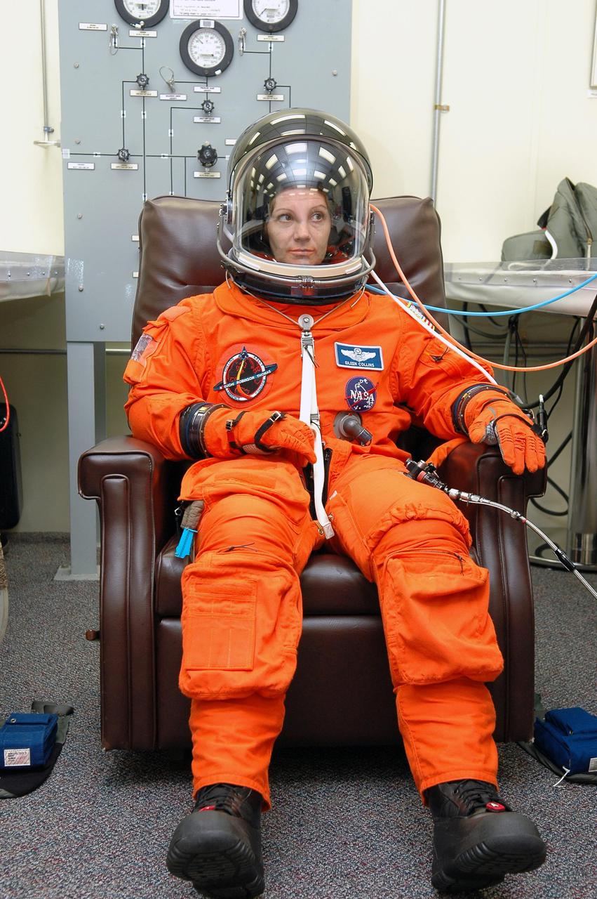 KENNEDY SPACE CENTER, FLA. -STS-114 Commander Eileen Collins suits up in the Operations and Checkout Building for the trip to Launch Pad 39B for a mock launch countdown culminating in a simulated main engine cutoff. The dress rehearsal is part of Terminal Countdown Demonstration Test (TCDT) activities held prior to each Space Shuttle flight. It provides the crew of each mission an opportunity to participate in various simulated countdown activities, including equipment familiarization and emergency egress training. STS-114 is the first Return to Flight mission to the International Space Station. The launch window extends July 13 through July 31.