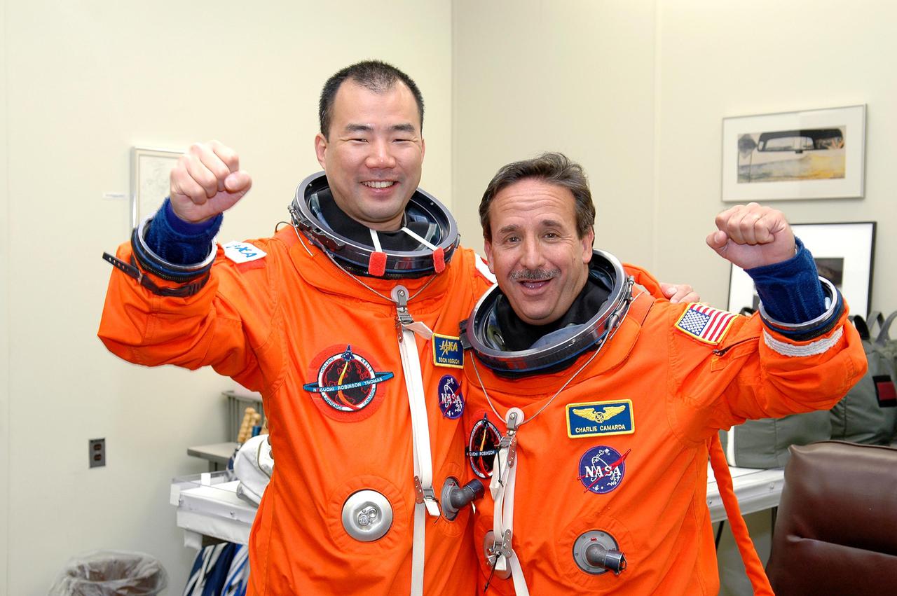 KENNEDY SPACE CENTER, FLA. - STS-114 Mission Specialists Soichi Noguchi (left) and Charles Camarda are suited up in the Operations and Checkout Building and ready for the trip to Launch Pad 39B for a mock launch countdown culminating in a simulated main engine cutoff. Noguchi is with the Japan Aerospace Exploration Agency. The dress rehearsal is part of Terminal Countdown Demonstration Test (TCDT) activities held prior to each Space Shuttle flight. It provides the crew of each mission an opportunity to participate in various simulated countdown activities, including equipment familiarization and emergency egress training. STS-114 is the first Return to Flight mission to the International Space Station. The launch window extends July 13 through July 31.