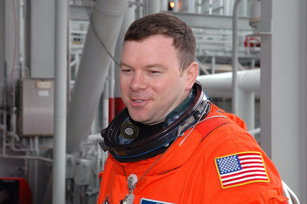 KENNEDY SPACE CENTER, FLA. - Following the mock countdown and emergency egress practice from the Fixed Service Structure on Launch Pad 39B, STS-114 crew members stop at the 225-foot level for a unique view. Seen here is Pilot James Kelly. This culminates the pre-launch training known as Terminal Countdown Demonstration Test (TCDT) activities. TCDT provides the crew of each mission an opportunity to participate in various simulated countdown activities, including equipment familiarization and emergency egress training. STS-114 is the first Return to Flight mission to the International Space Station. The launch window extends July 13 through July 31.