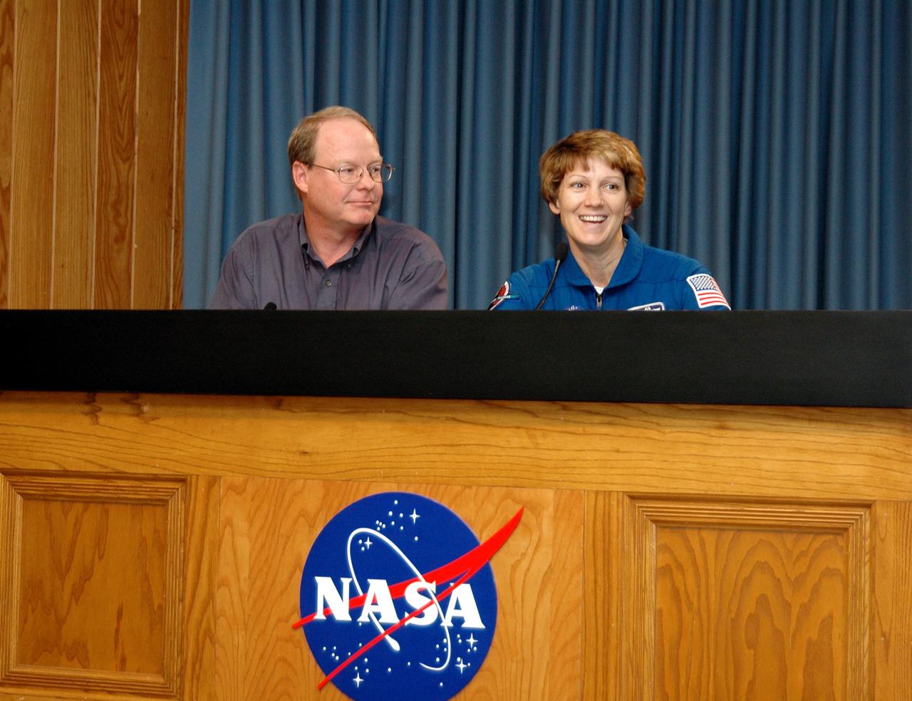 KENNEDY SPACE CENTER, FLA. - After the conclusion of Terminal Countdown Demonstration Test (TCDT) activities at NASA’s Kennedy Space Center, STS-114 Commander Eileen Collins briefly talks to media about the importance of the TCDT as pre-launch training. At left is NASA Public Information Officer Bruce Buckingham, who moderated. The TCDT provides the crew of each mission an opportunity to participate in various simulated countdown activities, including equipment familiarization and emergency egress training. STS-114 is the first Return to Flight mission to the International Space Station. The launch window extends July 13 through July 31.