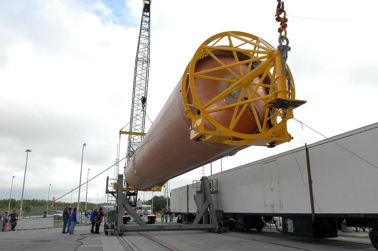 KENNEDY SPACE CENTER, FLA. - At Launch Complex 41 at Cape Canaveral Air Force Station in Florida, cranes raise the first stage of the Atlas V rocket, designated AV-007, which will be lifted up into the launch service tower and mated with the second stage, the Centaur. The Atlas V is the launch vehicle for the Mars Reconnaissance Orbiter (MRO). The MRO is designed for a series of global mapping, regional survey and targeted observations from a near-polar, low-altitude Mars orbit. These observations will be unprecedented in terms of the spatial resolution and coverage achieved by the orbiter’s instruments as they observe the atmosphere and surface of Mars while probing its shallow subsurface as part of a “follow the water” strategy. The orbiter is in KSC’s Payload Hazardous Servicing Facility for final assembly and testing. The launch window begins Aug. 10.