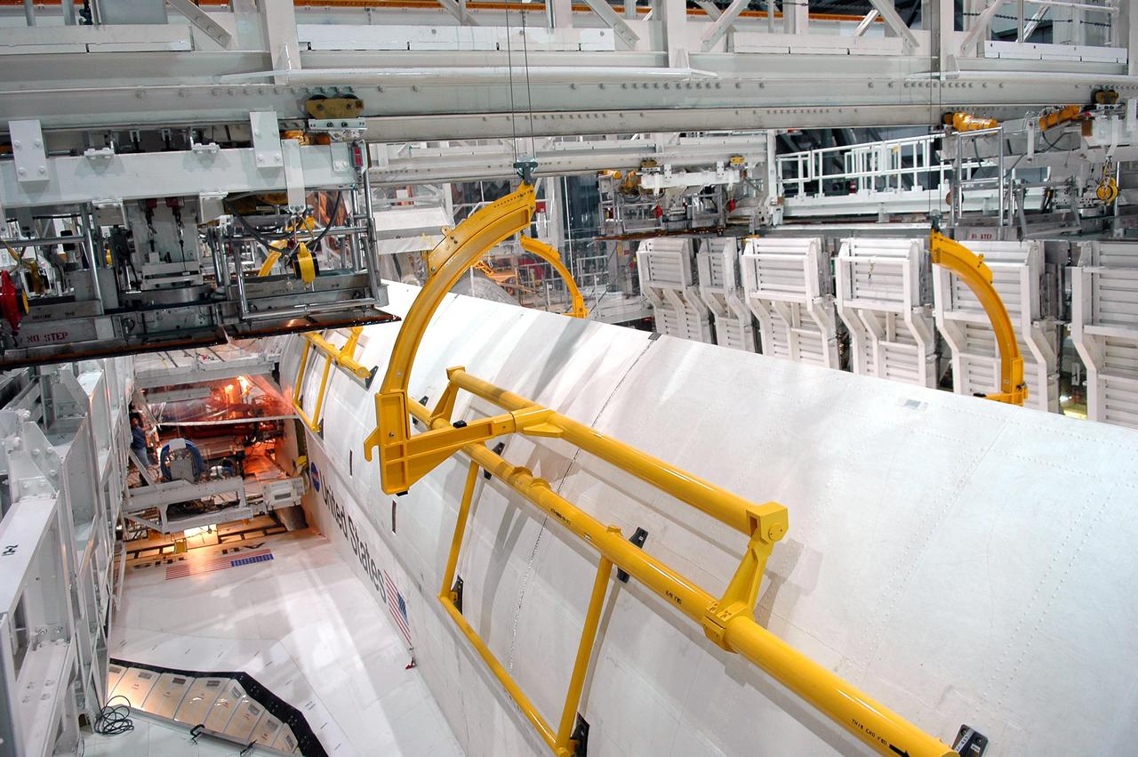 KENNEDY SPACE CENTER, FLA. - In Orbiter Processing Facility bay 1 at NASA’s Kennedy Space Center, Atlantis’ payload bay doors are partially opened. The 50-foot-long OBSS attaches to the Remote Manipulator System, or Shuttle arm, and is one of the new safety measures for Return to Flight.  It equips the orbiter with cameras and laser systems to inspect the Shuttle’s Thermal Protection System while in space.  Mission STS-121 is targeted for launch in September.  Once Atlantis' bay doors are open again, further work will be done in the bay.