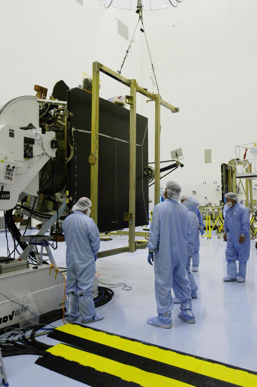 KENNEDY SPACE CENTER, FLA. - In the Payload Hazardous Servicing Facility, workers move a crane into place to remove the solar panel from the Mars Reconnaissance Orbiter spacecraft.  A major deployment test will check out the spacecraft’s large solar arrays.  The spacecraft will also undergo multiple mechanical assembly operations and electrical tests to verify its readiness for launch. The MRO was built by Lockheed Martin for NASA’s Jet Propulsion Laboratory in California.  It is the next major step in Mars exploration and scheduled for launch from Cape Canaveral Air Force Station in a window opening Aug. 10. The MRO is an important next step in fulfilling NASA’s vision of space exploration and ultimately sending human explorers to Mars and beyond.