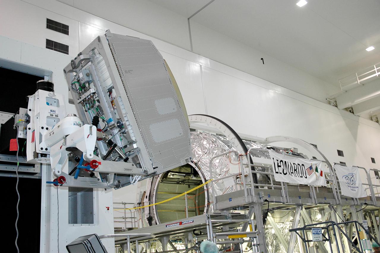 KENNEDY SPACE CENTER, FLA.  -  In the Space Station Processing Facility, the Minus Eighty Degree Laboratory Freezer for ISS (MELFI) science rack (left) is moved into position for installation into the Multi-Purpose Logisitics Module Leonardo. Leonardo will fly on Space Shuttle Atlantis on mission STS-121.  The MELFI will provide cooling and storage for scientific experiment samples and perishable materials in four insulated containers, known as dewars, with independently selectable temperatures of -80 degrees Celsius, -26 degrees Celsius, and +4 degrees Celsius.  MELFI will also be used to transport samples to and from the Station.  MELFI is provided as laboratory support equipment by the European Space Agency. STS-121 is the second Return to Flight mission to the International Space Station. The launch window extends from Sept. 9 through Sept. 24.