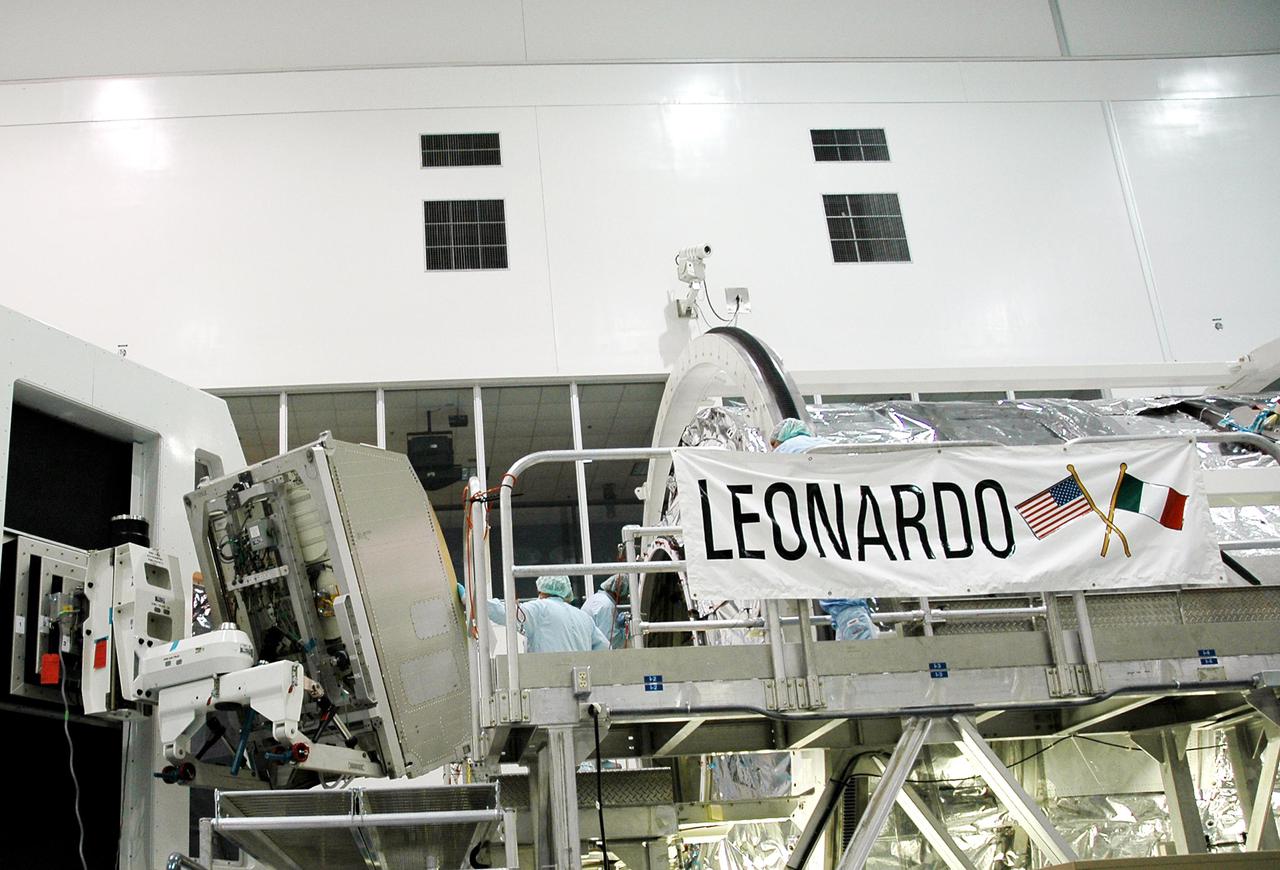 KENNEDY SPACE CENTER, FLA.  -  In the Space Station Processing Facility, technicians prepare to install the the Minus Eighty Degree Laboratory Freezer for ISS (MELFI) science rack into the Multi-Purpose Logisitics Module Leonardo. Leonardo will fly on Space Shuttle Atlantis on mission STS-121.  The MELFI will provide cooling and storage for scientific experiment samples and perishable materials in four insulated containers, known as dewars, with independently selectable temperatures of -80 degrees Celsius, -26 degrees Celsius, and +4 degrees Celsius.  MELFI will also be used to transport samples to and from the Station.  MELFI is provided as laboratory support equipment by the European Space Agency. STS-121 is the second Return to Flight mission to the International Space Station. The launch window extends from Sept. 9 through Sept. 24.