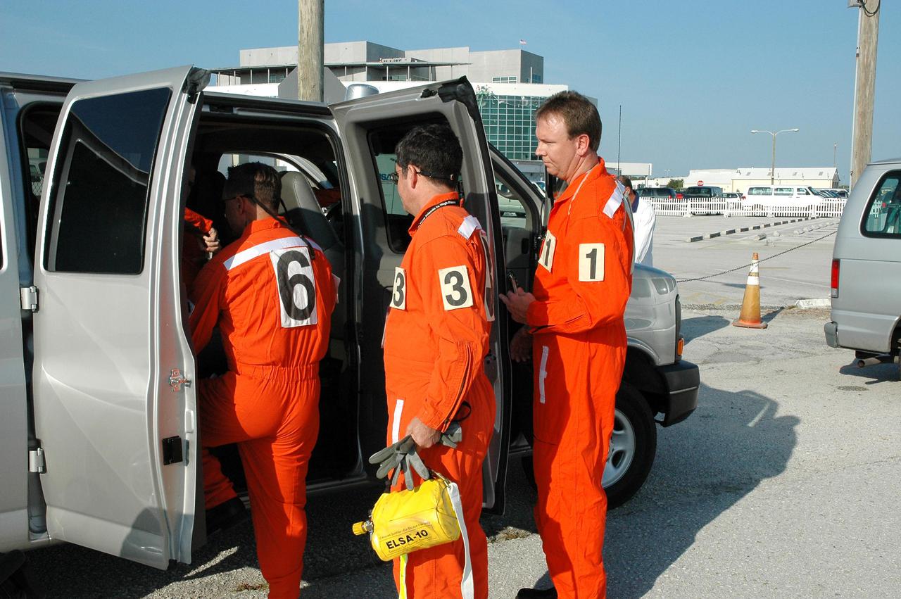 KENNEDY SPACE CENTER, FLA. - Members of the Final Inspection Team depart for Launch Pad 39B to support an External Tank (ET) tanking test. This team conducts a preflight walkdown of the vehicle and pad during the hold at T-3 hours on launch day. The tanking test is designed to evaluate how the tank, orbiter, solid rocket boosters and ground systems perform under 'cryo-load,' when the tank is filled with the two ultra-low-temperature propellants. The tank filling and draining portion of the test takes about 11 hours. The test also includes a simulated countdown through the hold at T-31 seconds. The test is being conducted to troubleshoot two issues identified by a tanking test held on April 14. Data is being collected to analyze the liquid hydrogen sensors that gave intermittent readings and the liquid hydrogen pressurization relief valve that cycled more times than standard. The tanking tests are part of preparations for Space Shuttle Discovery's Return to Flight mission, STS-114, to the International Space Station. The launch window extends from July 13 through July 31.